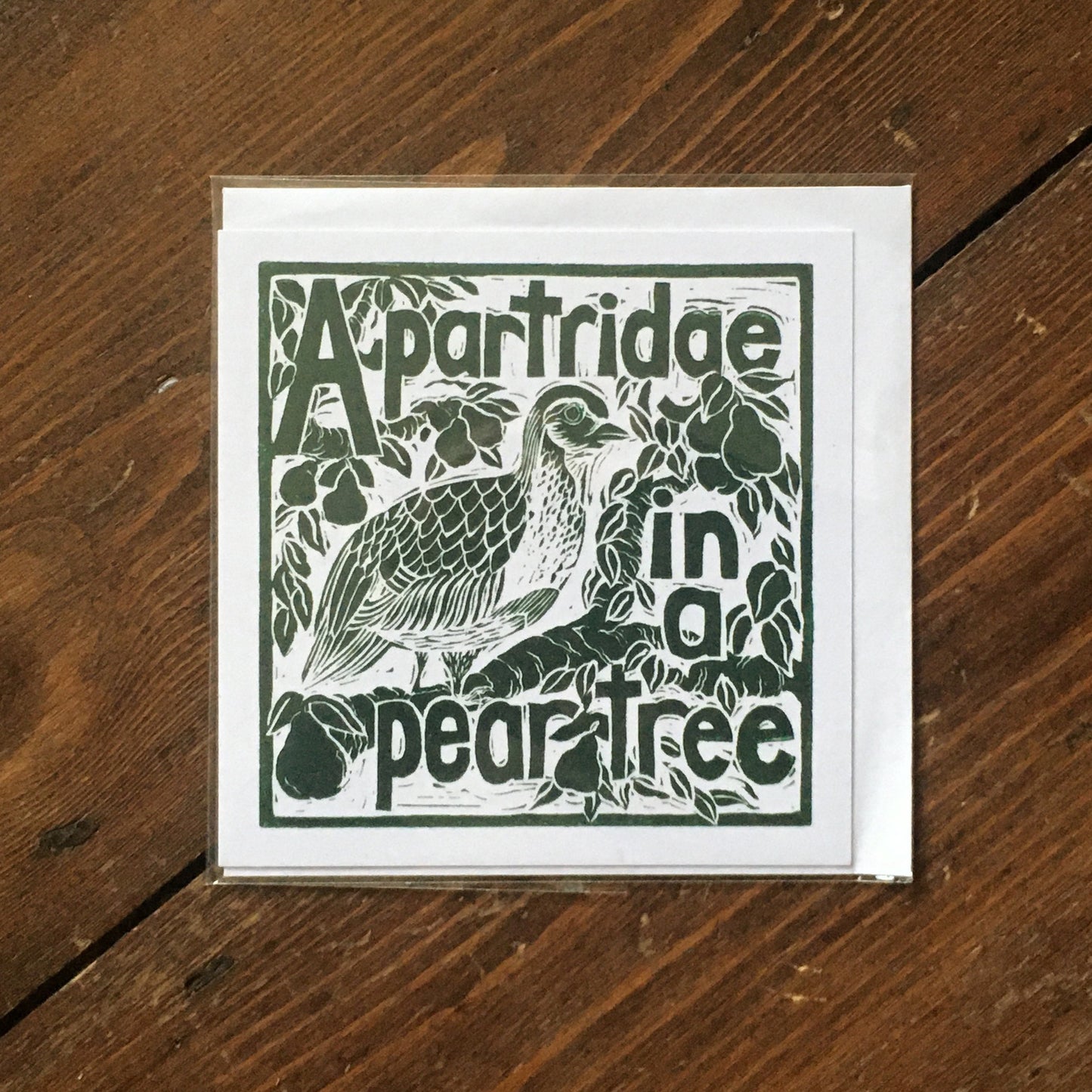 A Partridge in a pear tree greetings card lino cut by Kate Guy