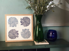 Load image into Gallery viewer, Scallop Shell Handmade tile trivet, table centrepiece. Linocut print of scallop shells on four tiles framed in English oak
