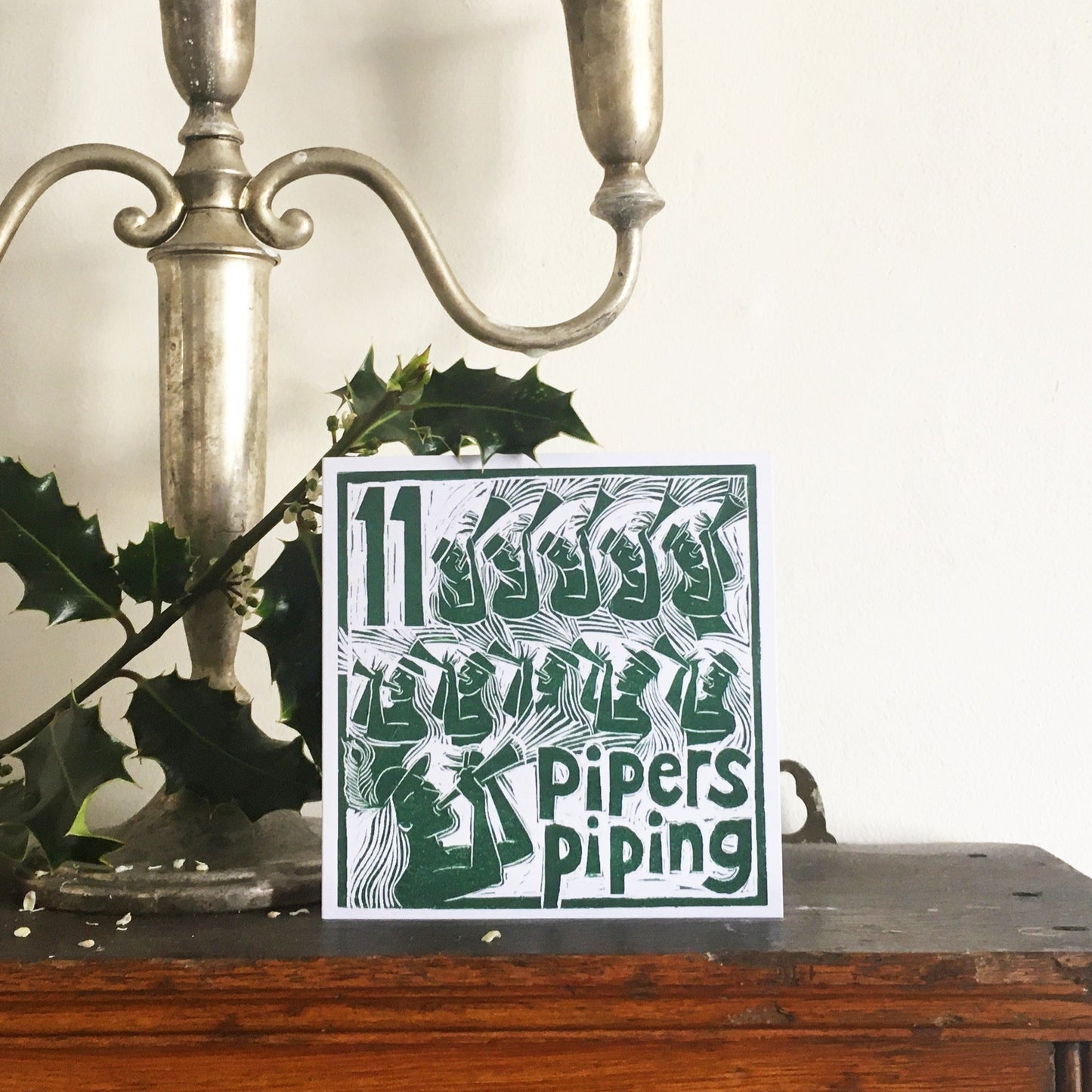 Eleven Pipers Piping Greetings Card lino cut by Kate Guy