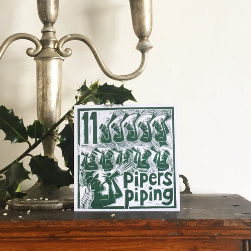 Eleven Pipers Piping Greetings Card lino cut by Kate Guy