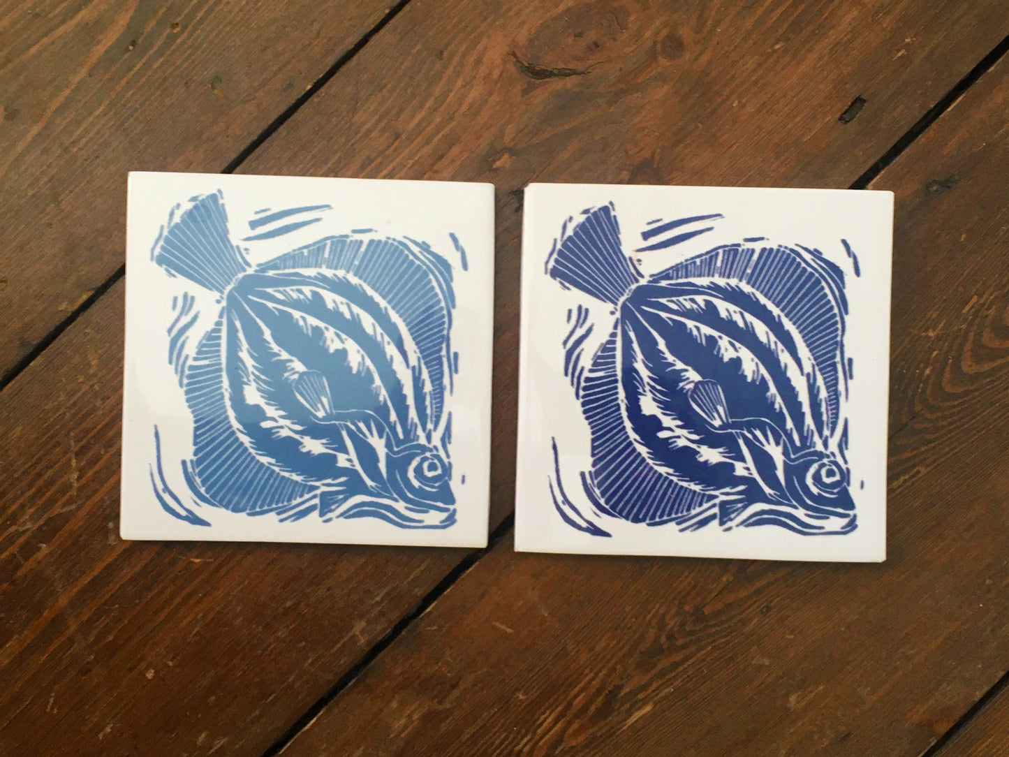 Plaice handmade tile trivet lino cut by Kate Guy pair in dark and light blue