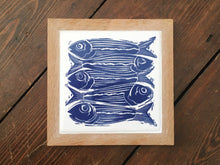 Load image into Gallery viewer, Sardines Handmade tile trivet, Linocut print of 5 fish ON HANDMADE TILE framed in English oak

