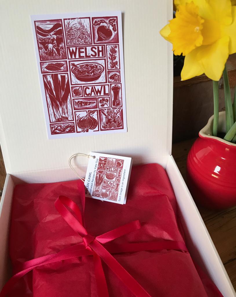 Welsh Cawl Gift Set Tea Towel Apron and Oven gloves wrapped in tissue presented in a gift box