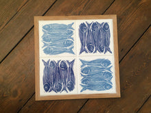Load image into Gallery viewer, Sardines tile trivet table centrepiece in oak frames lino cut by Kate Guy in dark and pale blue
