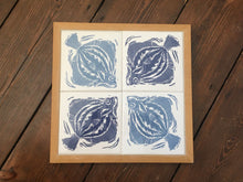 Load image into Gallery viewer, Plaice Handmade tile trivet, table centrepiece. Linocut print of fish on four tiles framed in English oak.
