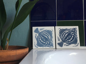 Plaice handmade tile trivet lino cut by Kate Guy pair in dark and light blue